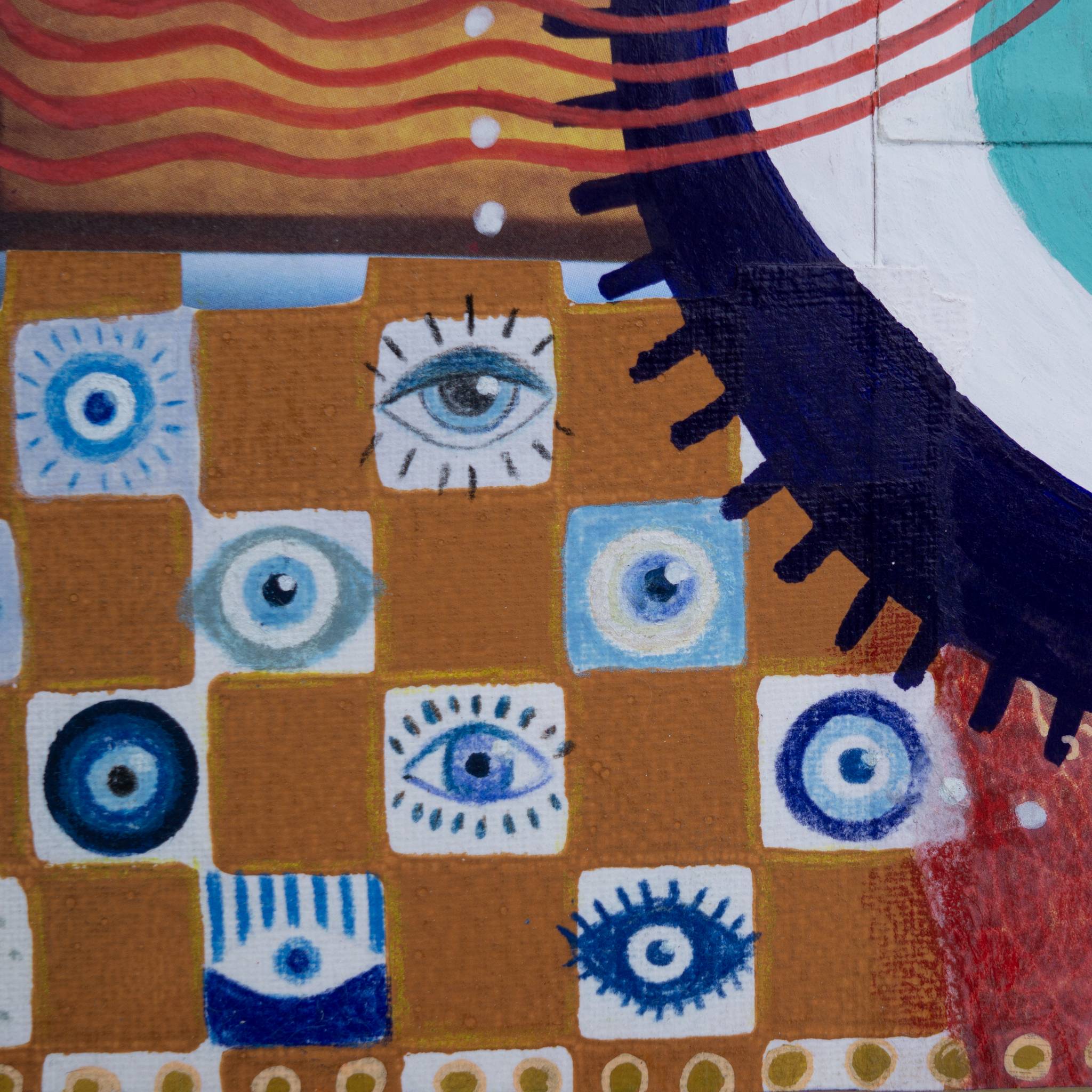 Detail of mixed media collage art showing hand drawn eye patterns and abstract designs