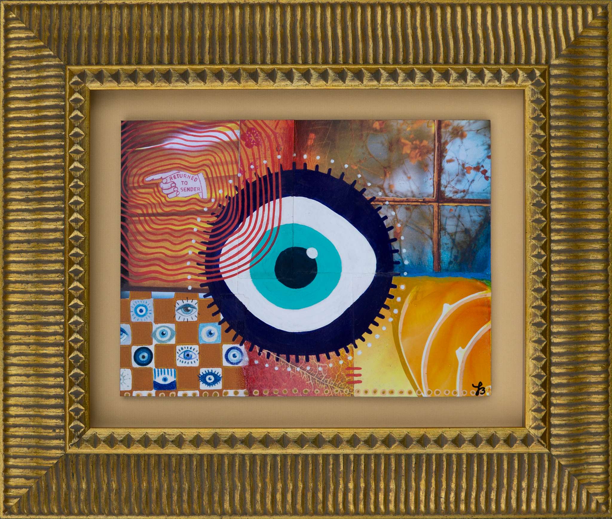 Framed mixed media collage artwork with a central evil eye design surrounded by colorful patterns in a gold frame with mat.