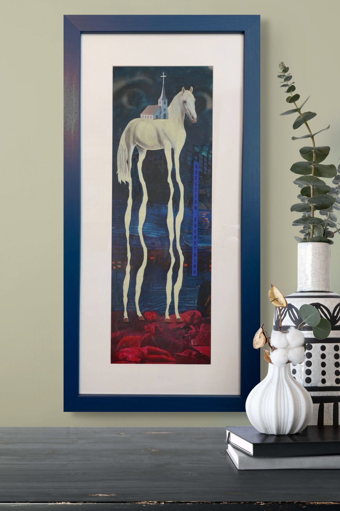 Framed artwork of a horse with a blue frame on a wall.